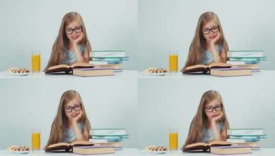 女孩戴着眼镜阅读课本 高清在线视频素材下载