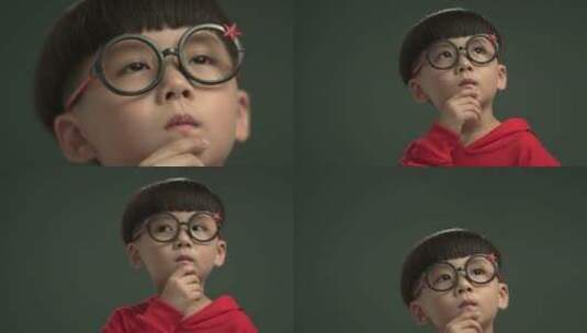 戴眼镜小男孩思考样子高清在线视频素材下载
