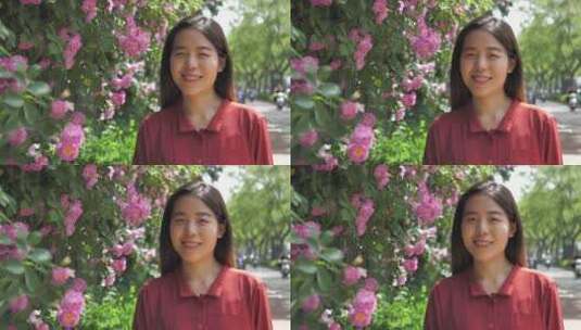 中国女性路边观赏盛开的蔷薇花高清在线视频素材下载
