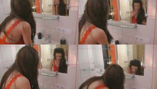 女人对着镜子整理头发高清在线视频素材下载