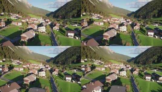 日落阿尔卑斯山绿色山谷中奥地利村庄的鸟瞰图高清在线视频素材下载