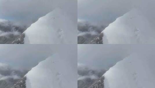 航拍攀登横断山脉乌库楚雪山山脊上的登山者高清在线视频素材下载