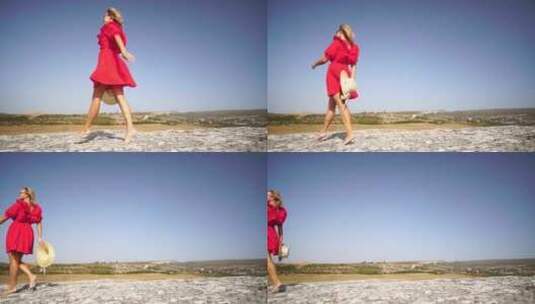 红裙草帽女子站在岩石上享受新鲜空气拥抱自高清在线视频素材下载