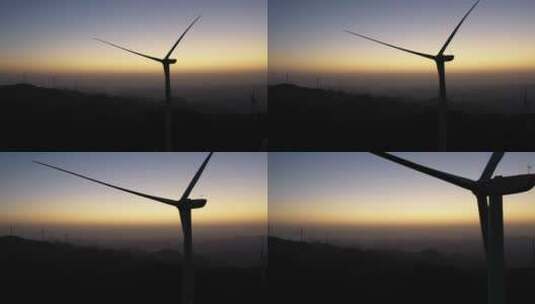 实拍清晨日出前飞机穿过风力发电机高清在线视频素材下载