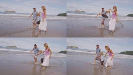 父母牵着孩子在沙滩漫步高清在线视频素材下载