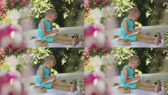 在花园里桌子上读书的女孩高清在线视频素材下载