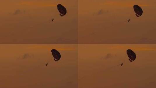 一对情侣在夕阳的风中享受滑翔伞运动_高清在线视频素材下载