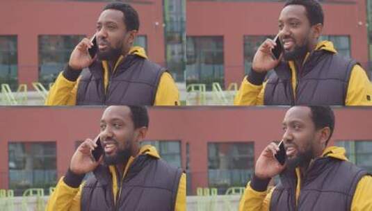 非洲裔美国男子走在街上打电话高清在线视频素材下载