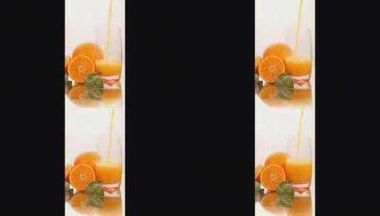 在白色背景上有一些橙子的玻璃杯里供应果汁高清在线视频素材下载