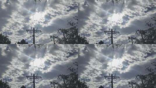 阳光下的云朵与电线杆高清在线视频素材下载