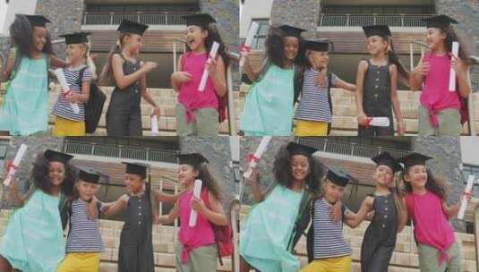 快乐的多样化女孩戴着毕业帽拿着文凭的视频高清在线视频素材下载