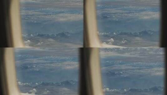 从飞机窗户看窗外崇山峻岭水墨画云层山峰高清在线视频素材下载