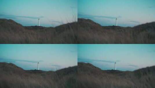 4K-草丛低视角看海边的灯塔高清在线视频素材下载