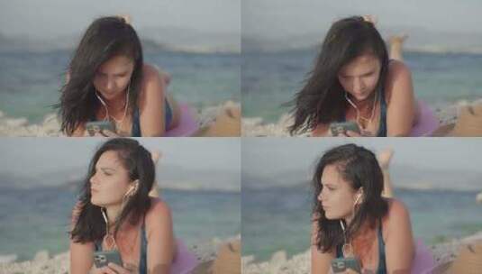 生活方式女孩躺在沙滩上用耳机听音乐高清在线视频素材下载