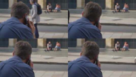 一名男子坐在街上打电话高清在线视频素材下载