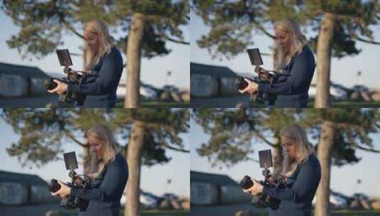 女摄影师调节相机镜头 高清在线视频素材下载
