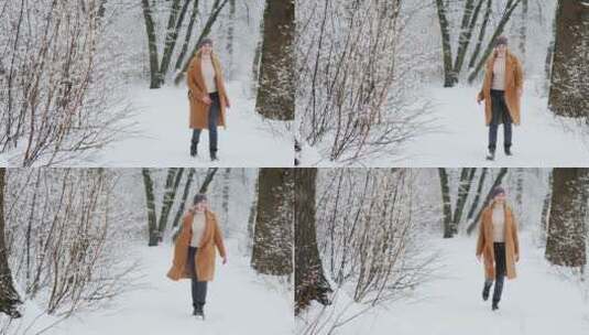 时尚女人走在白雪皑皑的树林里高清在线视频素材下载