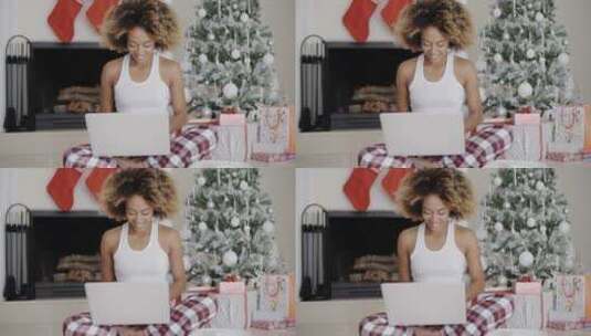 圣诞树前玩电脑的女人高清在线视频素材下载