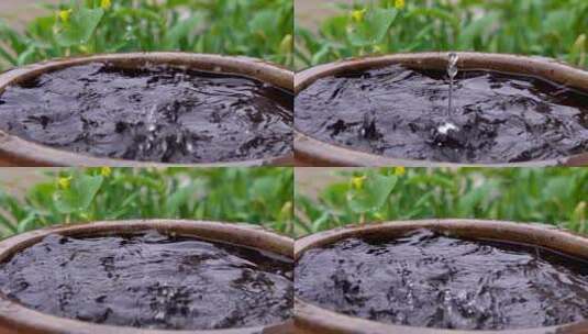 下雨天雨水滴落在水缸高清在线视频素材下载