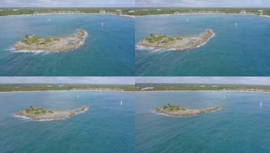 在加勒比海绿松石色的海上环绕着岩石小岛航行的帆船；空中航行的高清在线视频素材下载
