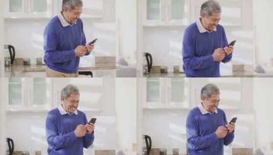 快乐男人在厨房使用智能手机高清在线视频素材下载