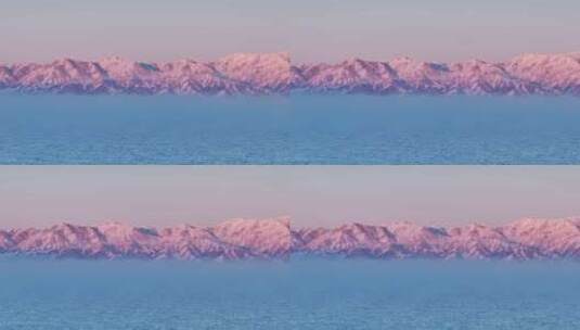 新疆博州赛里木湖冬季日落粉调雪山航拍高清在线视频素材下载