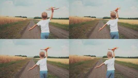 小男孩拿着玩具飞机在田间小路上奔跑高清在线视频素材下载