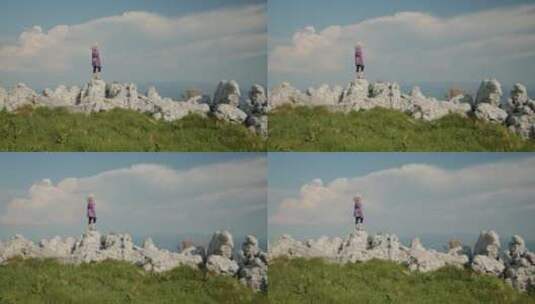 女人站在岩石上看风景高清在线视频素材下载