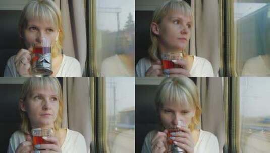 女人坐在火车窗边喝茶高清在线视频素材下载