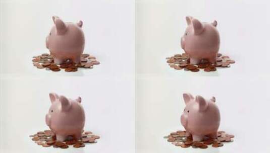 小猪存钱罐边的钱币高清在线视频素材下载