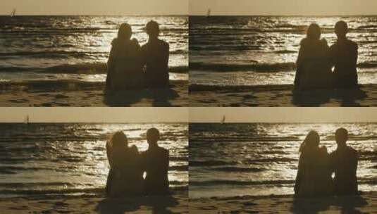 情侣坐在海边剪影高清在线视频素材下载