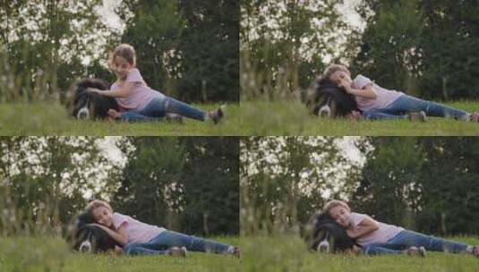草坪上小女孩拥抱宠物狗高清在线视频素材下载