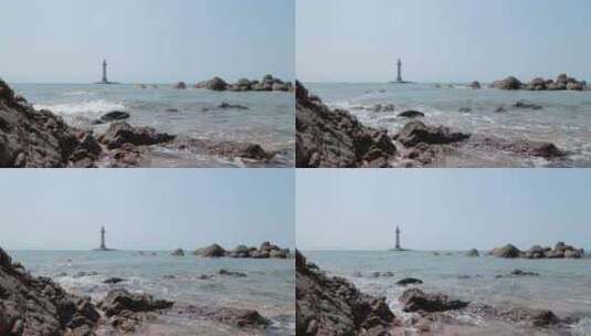 晴天下的海上灯塔和冲向岸边的浪花高清在线视频素材下载