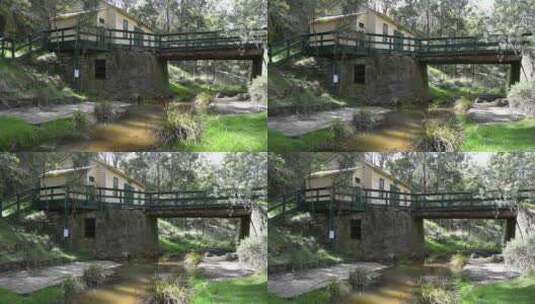 在小溪或小溪上的一座古老的木制和石桥，旁高清在线视频素材下载