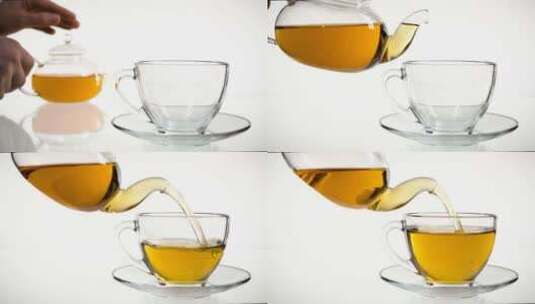 倒茶。茶倒入玻璃透明茶杯。喝茶时间。透明高清在线视频素材下载