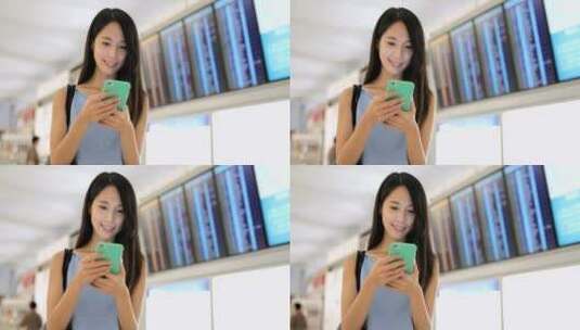 女孩在机场看手机高清在线视频素材下载