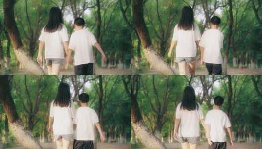 男孩女孩牵手在公园散步的背影4k视频高清在线视频素材下载