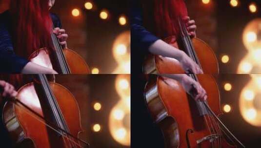 一个红头发的女人拉大提琴高清在线视频素材下载