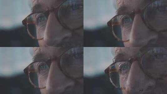 戴眼镜的老人眨眼的特写高清在线视频素材下载