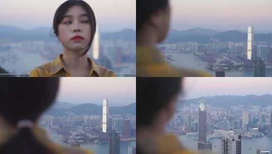 游客女性站在太平山山顶上看香港城市风景高清在线视频素材下载
