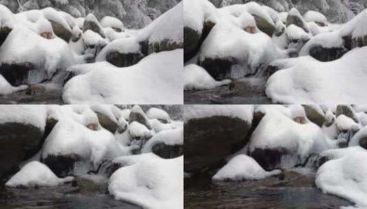 晶莹剔透的溪流在积雪覆盖的岩石中流动高清在线视频素材下载