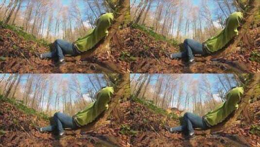 一个女人和她的狗躺在森林里高清在线视频素材下载