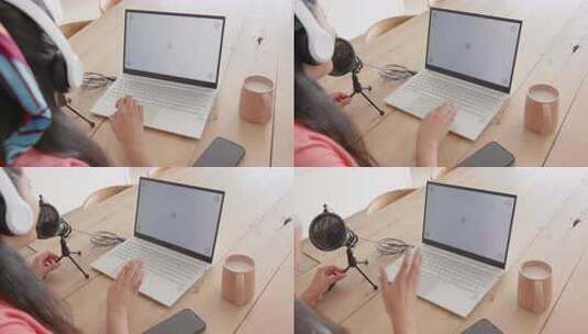 使用笔记本电脑和麦克风，亚洲女性在桌子上高清在线视频素材下载