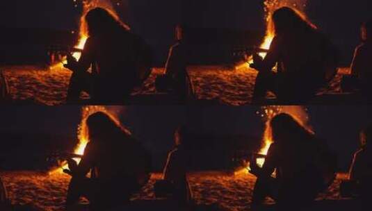 男人在海滩篝火旁弹吉他高清在线视频素材下载