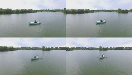 情侣在池塘上划船高清在线视频素材下载