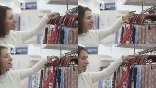 女孩在商城挑选印花织物高清在线视频素材下载