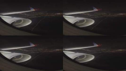 飞机舷窗外夜晚现代城市风光和机翼高清在线视频素材下载