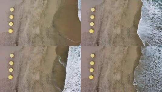 黄色雨伞海岸线无人机飞越海滩高清在线视频素材下载