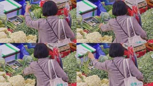 菜市场买菜挑选蔬菜的女人高清在线视频素材下载