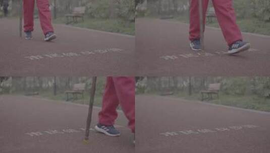 老人拄着拐杖在跑道上走过高清在线视频素材下载